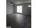 Spacious living room with grey wood-look flooring and a large window at 1059 Garibaldi Sw St, Atlanta, GA 30310