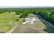 Expansive aerial view of a home with a large front yard, outbuildings, pastures, and mature trees at 3170 Double Bridges Rd, Rutledge, GA 30663