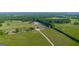 Sprawling property featuring pastures, mature trees, outbuildings, and a long winding driveway at 3170 Double Bridges Rd, Rutledge, GA 30663