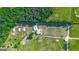 Aerial view of a home with multiple barns and fenced pastures amidst green fields and scattered trees at 3170 Double Bridges Rd, Rutledge, GA 30663