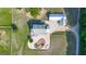 Aerial view showcasing the home's layout with a circular driveway, outbuildings, and a well-maintained yard at 3170 Double Bridges Rd, Rutledge, GA 30663