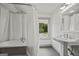 Classic bathroom with pedestal sink, tub, and window view at 3170 Double Bridges Rd, Rutledge, GA 30663