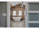 Spa-like bathroom with freestanding tub and stone accent wall at 3170 Double Bridges Rd, Rutledge, GA 30663