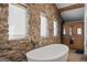 Spa-like bathroom with freestanding tub, stone walls, and sauna at 3170 Double Bridges Rd, Rutledge, GA 30663