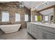 Bathroom showcasing a standalone tub, stone wall accents, double vanity sinks, and modern fixtures at 3170 Double Bridges Rd, Rutledge, GA 30663