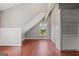 Attic bedroom showcasing hardwood floors, a window with a view, and built-in closet in a neutral color palette at 3170 Double Bridges Rd, Rutledge, GA 30663
