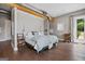 Main bedroom with hardwood floors, access to patio, and natural light at 3170 Double Bridges Rd, Rutledge, GA 30663