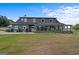 Back of house showing a large sunroom addition at 3170 Double Bridges Rd, Rutledge, GA 30663