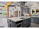 Modern kitchen with gray cabinets, large island, and breakfast bar at 3170 Double Bridges Rd, Rutledge, GA 30663