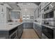 Modern kitchen with gray cabinets, island, and stainless steel appliances at 3170 Double Bridges Rd, Rutledge, GA 30663