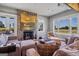 Cozy living room with stone fireplace and large windows at 3170 Double Bridges Rd, Rutledge, GA 30663