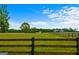 View of a home from a large pasture with wooden fence at 3170 Double Bridges Rd, Rutledge, GA 30663