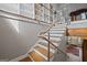 Modern staircase with metal railing and built-in bookcase at 3170 Double Bridges Rd, Rutledge, GA 30663