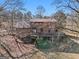 Two-story home with wraparound deck and wooded surroundings at 2535 Rock Springs Rd, Buford, GA 30519