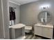 Bathroom featuring a tub and vanity with a decorative round mirror at 1771 Ware Ave, East Point, GA 30344
