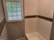 Bathroom area with unique tiled wall and a tub with shower at 1771 Ware Ave, East Point, GA 30344