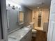 Bathroom featuring tile flooring, vanity with marble countertop, and tiled shower with accents at 1771 Ware Ave, East Point, GA 30344