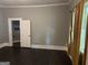 Neutral bedroom with hardwood floors and doorway to tiled bathroom at 1771 Ware Ave, East Point, GA 30344