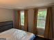 Comfortable bedroom featuring three bright windows and neutral-toned walls at 1771 Ware Ave, East Point, GA 30344