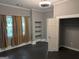 Bedroom with closet, built-in shelving, and multiple windows with curtains at 1771 Ware Ave, East Point, GA 30344