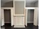 View of bedroom with dark floors, closet, and a decorative fireplace with mirror in between closets at 1771 Ware Ave, East Point, GA 30344