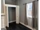 Bedroom featuring dark floors, a closet, a window, and decorative white molding accents at 1771 Ware Ave, East Point, GA 30344