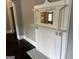 Close up view of a decorative white fireplace with an ornate mirror and dark flooring at 1771 Ware Ave, East Point, GA 30344
