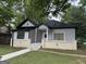 Charming home with grey siding, black roof, and inviting front porch at 1771 Ware Ave, East Point, GA 30344