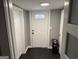 Hallway featuring a door with a patterned glass window and black wood floors at 1771 Ware Ave, East Point, GA 30344