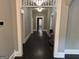 An open hallway has dark wood floors, gray walls and white molding and trim at 1771 Ware Ave, East Point, GA 30344