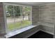 Interior view of a room with shiplap walls, window and black floors at 1771 Ware Ave, East Point, GA 30344