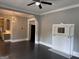 Open-concept living room view into kitchen, featuring dark floors and bright decorative lighting at 1771 Ware Ave, East Point, GA 30344