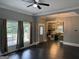 Living room with windows, dark floors, gray walls, and an open-concept view of the kitchen at 1771 Ware Ave, East Point, GA 30344