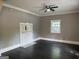 View of living room with dark floors, a ceiling fan, and a decorative fireplace with mirror at 1771 Ware Ave, East Point, GA 30344