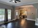 View of living room with windows, dark floors, gray walls, and open-concept to the kitchen at 1771 Ware Ave, East Point, GA 30344