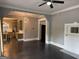 Open-concept living room view into kitchen, featuring dark floors and bright, decorative lighting at 1771 Ware Ave, East Point, GA 30344