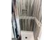 Close-up of a walk-in shower featuring gray wood-look tiles at 1771 Ware Ave, East Point, GA 30344