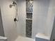 Updated shower with white subway tile, bronze fixtures, and decorative tiled wall accent with niche at 1771 Ware Ave, East Point, GA 30344