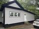 Side exterior view of home with gray siding and a white door at 1771 Ware Ave, East Point, GA 30344
