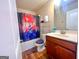 Clean bathroom with shower/tub combo and wood-look flooring at 11958 Quail Dr, Hampton, GA 30228