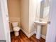 Small half bathroom with pedestal sink and toilet at 11958 Quail Dr, Hampton, GA 30228