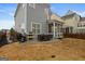 Cozy backyard patio with screened porch, grill, and seating area at 200 Jamestowne Pass, Peachtree City, GA 30269