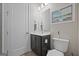 Modern bathroom with dark vanity and white toilet at 200 Jamestowne Pass, Peachtree City, GA 30269
