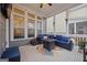 Relaxing screened porch with comfortable seating and a fire pit at 200 Jamestowne Pass, Peachtree City, GA 30269