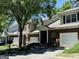 Townhouse exterior with brick facade, attached garage, and mature trees at 2567 Laurel Nw Cir, Atlanta, GA 30311