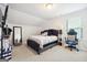 Cozy bedroom with a queen bed, stylish decor, and a gaming chair at 361 Elkins Pl, Peachtree City, GA 30269
