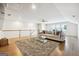 Bonus room boasts hardwood floors, large sectional sofa, and a comfy rug at 361 Elkins Pl, Peachtree City, GA 30269