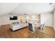 Bright bonus room features hardwood floors, a sectional sofa, and a dining area at 361 Elkins Pl, Peachtree City, GA 30269