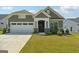 Craftsman style home with two-car garage and landscaped lawn at 361 Elkins Pl, Peachtree City, GA 30269