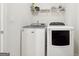 Convenient laundry room with washer, dryer and shelving for storage at 361 Elkins Pl, Peachtree City, GA 30269
